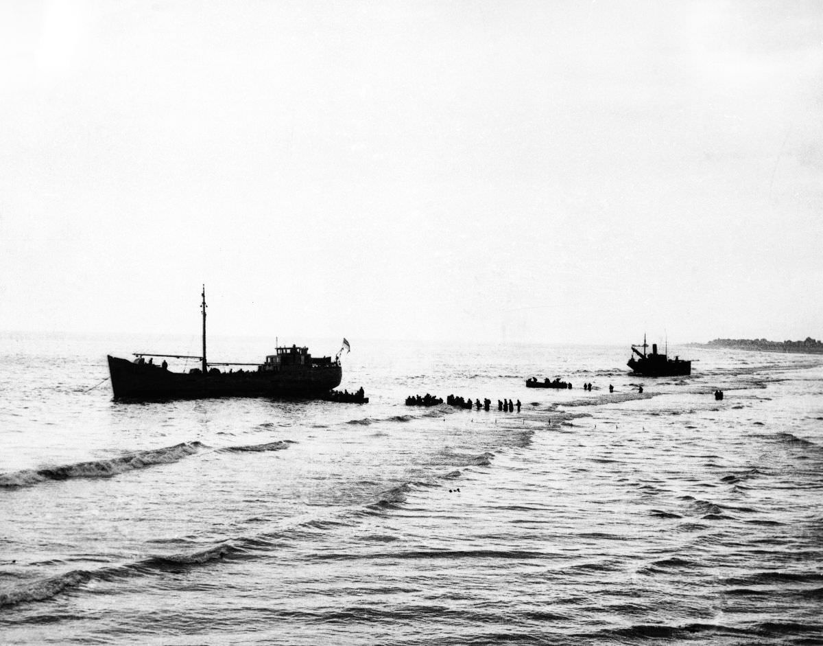 British Expeditionary Forces wade out to one of the “little ships” aiding the evacuation